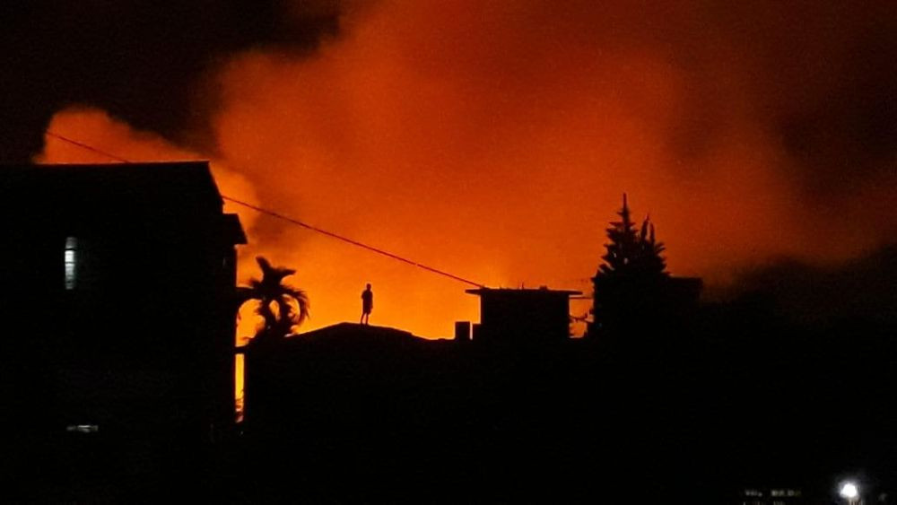 A man is silhouetted by the flames of a massive fire that broke out near the truck parking area, Khemahal in Dimapur at around 8:00 pm on the night of November 11. Fire trucks from all Dimapur (Central), Dimapur (West) and Chumuokedima fire stations were pressed into service. Fire fighters managed to bring the flames under control at around 10:30pm. While the damage or cause of the fire could not be ascertained till the filing of this report, it was informed that around 8 explosions possibly caused by bursting gas cylinders could be heard as the fire raged. (Photo Courtesy: Sentilong Imchen)